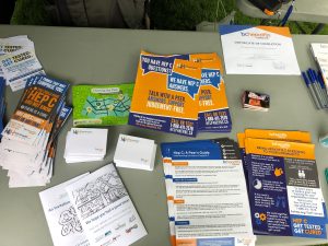 table with literature, help4hep bc posters, hep c peer guide, help4hep bc post it notes, handout about hepatitis C information and point of care testing